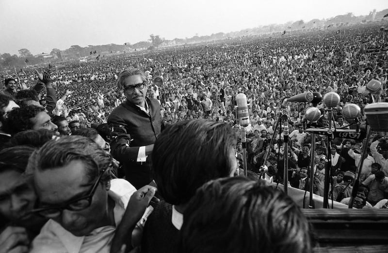 Bengali nationalist leader Sheikh Mujibur Rahman walks towards a battery of microphones to address an estimated 1 million people at a rally at the Race Course Ground in Dhaka, Jan. 11, 1972. Mujibur, the first leader of independent Bangladesh and the father of current Prime Minister Sheikh Hasina, was assassinated in a military coup in August 1975. (Michel Laurent/AP)