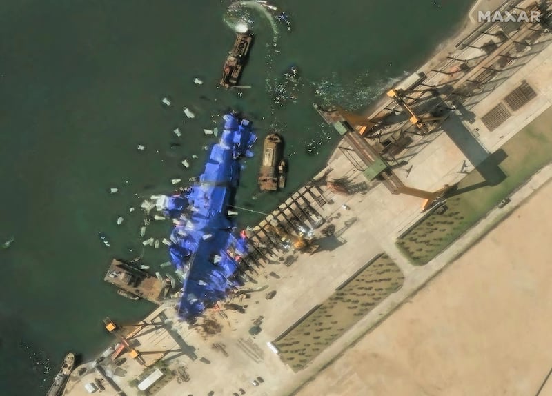This May 24, 2025, satellite image shows a North Korean warship covered with a blue tarp after an accident that occurred during its launch at the shipyard, in Chongjin, North Korea.