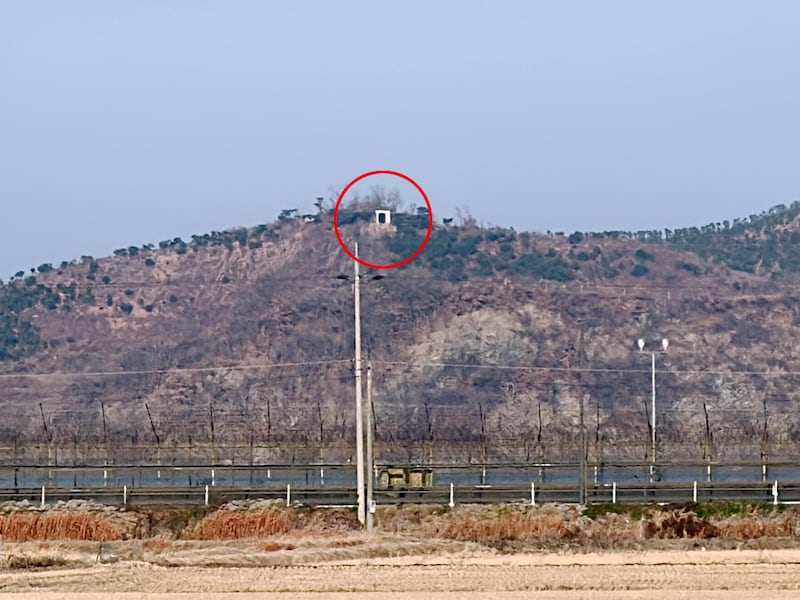 A speaker, the white box inside red circle, sits on top of a mountain in North Korea, and is aimed at residents across the border in South Korea.