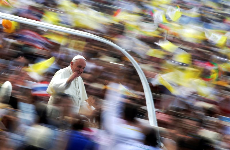 Pope Francis waves as he arrives to lead a mass at Kyite Ka San Football Stadium in Yangon, Myanmar, Nov. 29, 2017.