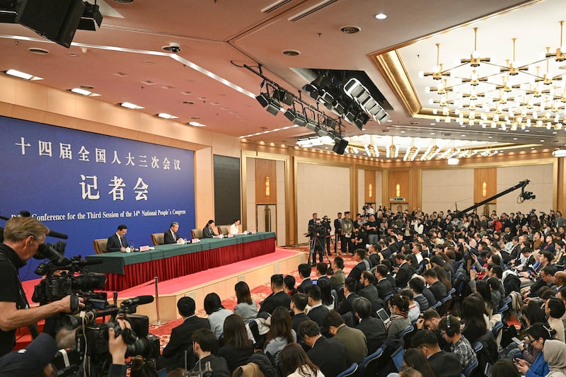 China’s Foreign Minister Wang Yi, podium, 2nd from left, speaks at a press conference during the ongoing National People’s Congress in Beijing on March 7, 2025.
