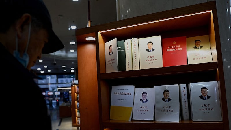 2021 年 11 月 8 日，一名男子在北京一家书店看有关中国国家主席习近平的书籍。（法新社）